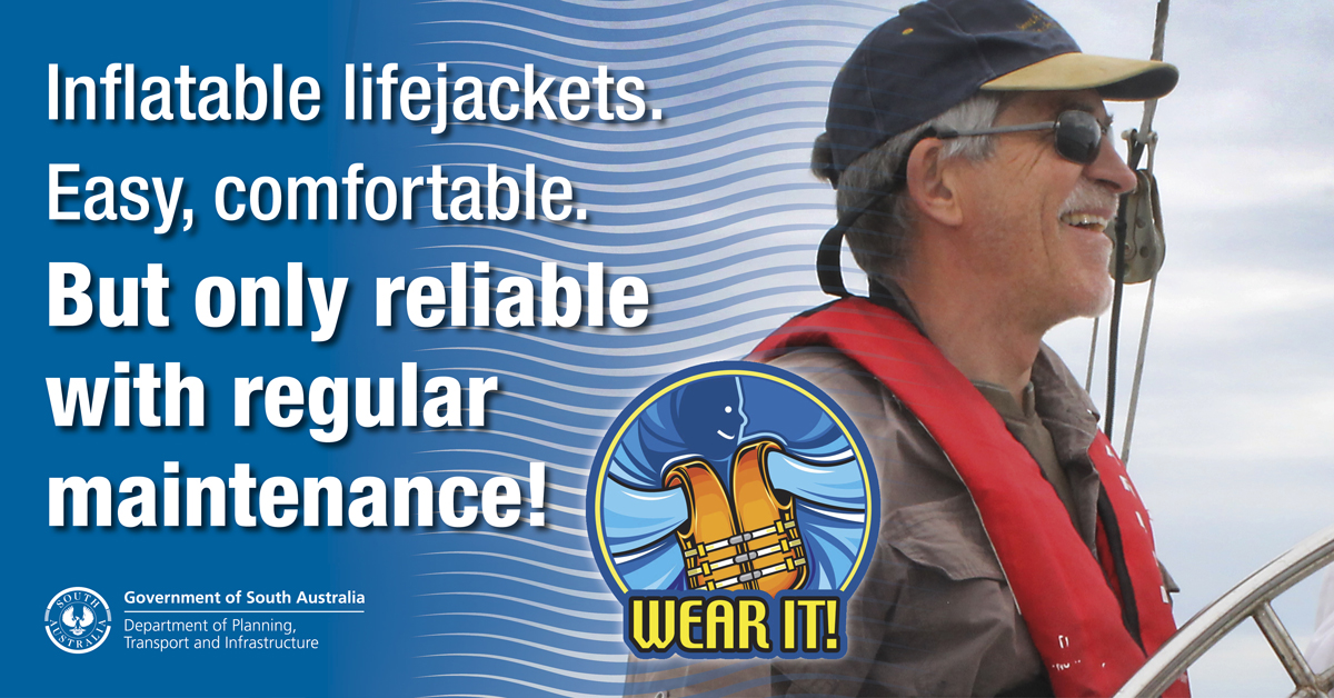 White words on a blue background read "Inflatable lifejacketts. Easy, comfortable. But only with regular maintenance!" To the right of this is a logo with a stylised lifejacket above the words "Wear it!". This is set in the lower left potion over an image joined to the first words, showing a man wearing cap, sunglasses, a brown shirt and a red lifejacket., The man appears to be sailing a boat.