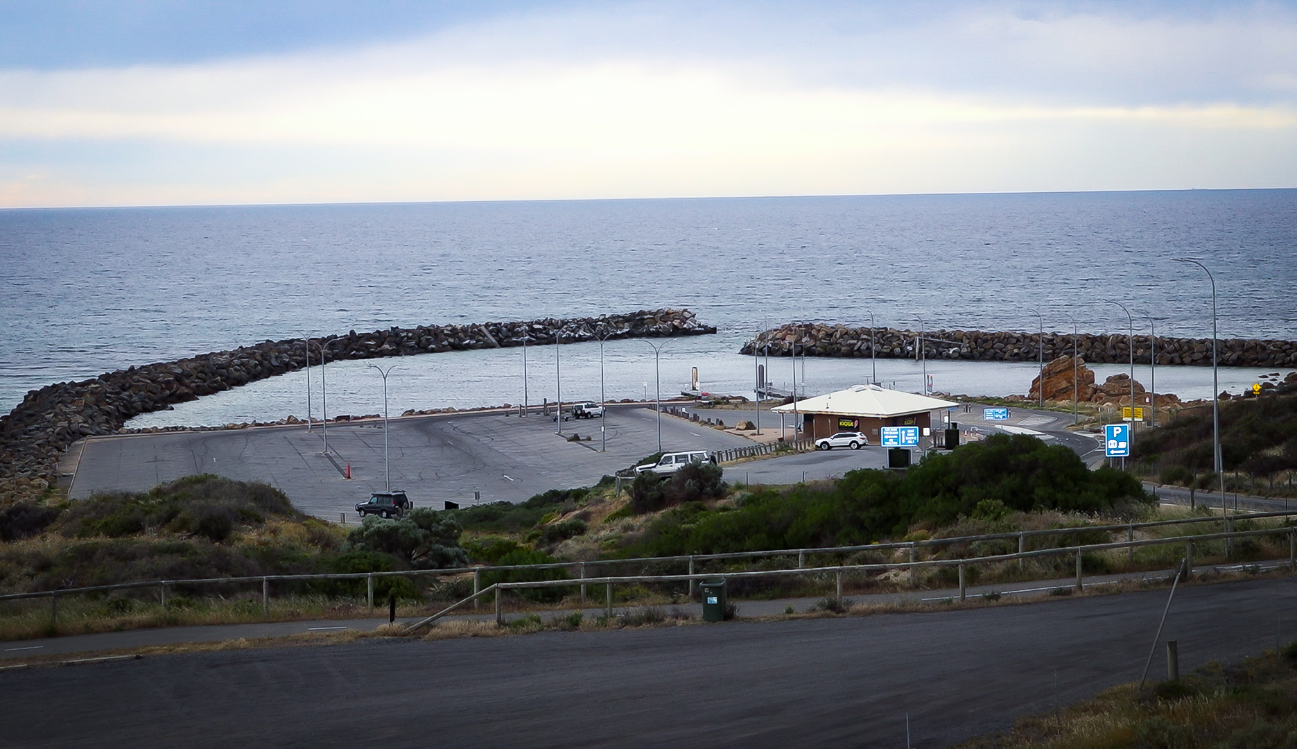 A view of the O'Sullivan Beach car park, kiosk and boat ramp, taken from a hill.