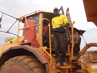 Man standing on the stairs of a large truck